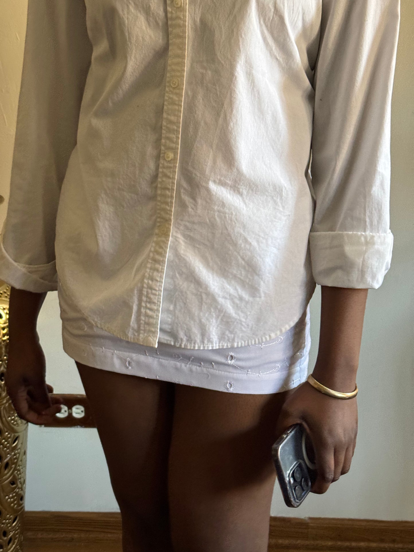 Model in Moonviel Skirt walking through sun-drenched streets, styled for minimal luxe fashion.