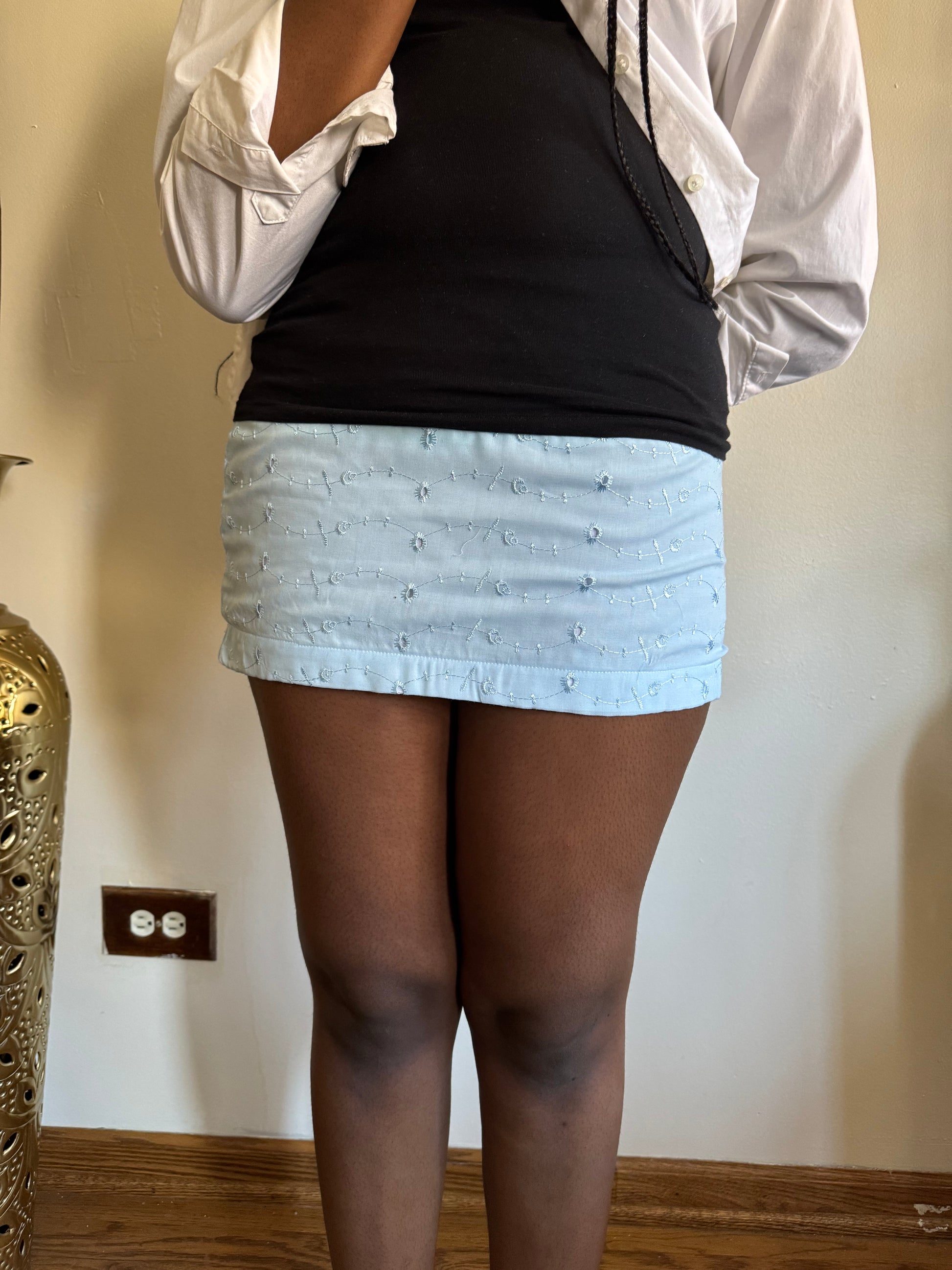 On-Body Model Of Lightweight mini skirt with dreamy movement, ideal for Hamptons trips and seaside walks.