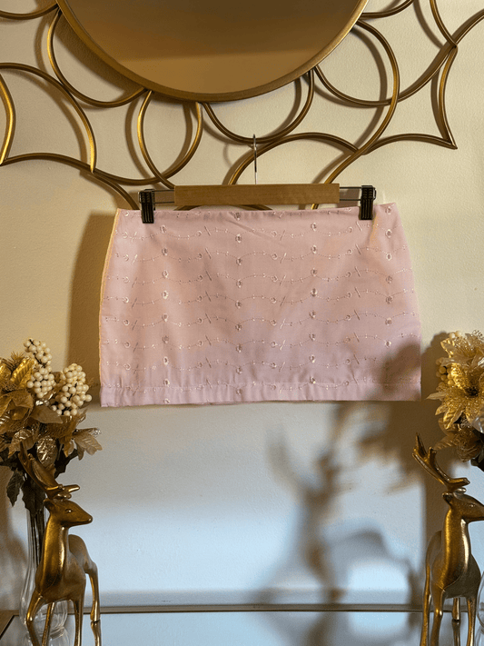 Blush pink eyelet mini skirt with floral embroidery from Lola’s Digicam, styled for Parisian summer.