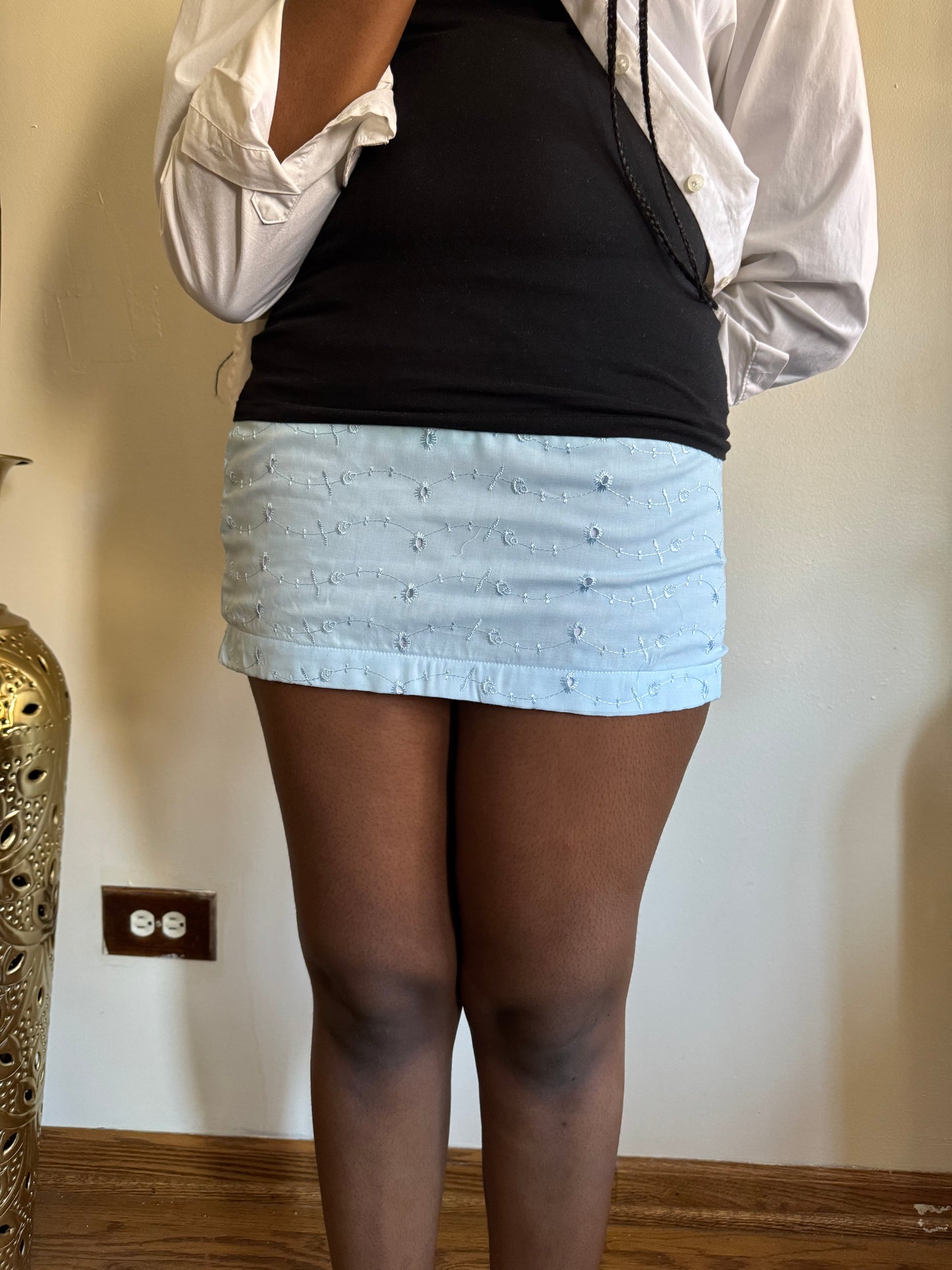 On-Body Model Of Lightweight mini skirt with dreamy movement, ideal for Hamptons trips and seaside walks.