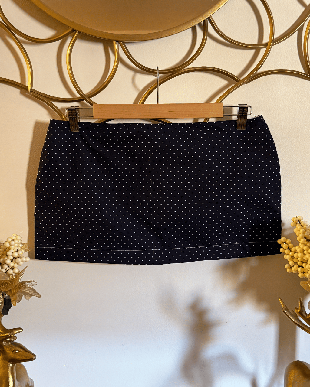 Navy blue cotton mini skirt with ivory polka dots by Lola’s Digicam, styled for city nights and rooftop dates.